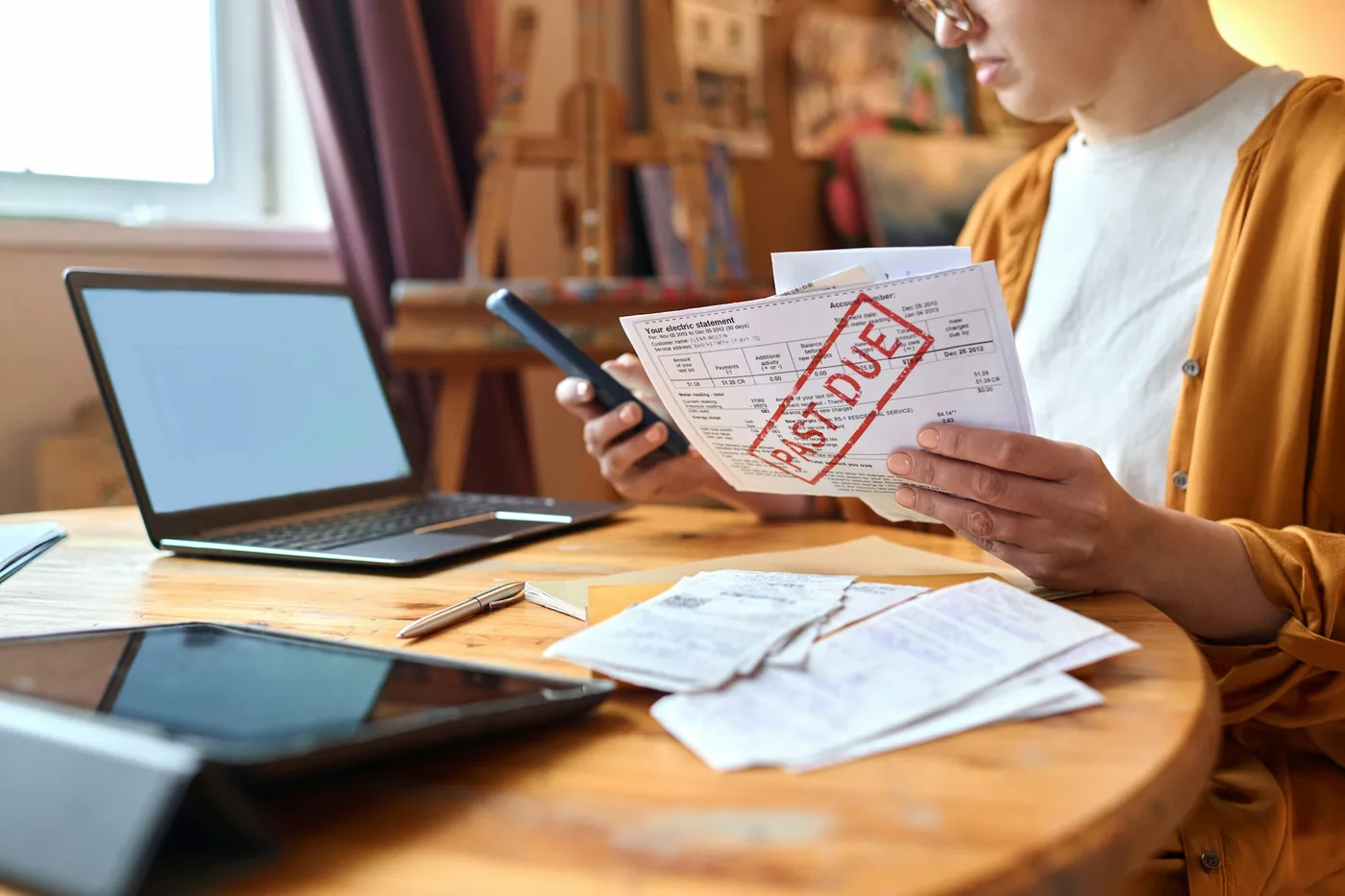 Woman sorting past due bills